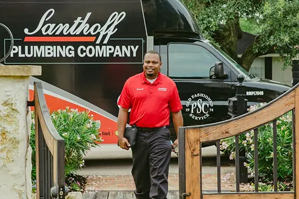Houston plumbing walking from Santhoff Plumbing truck to fix clogged plumbing vent