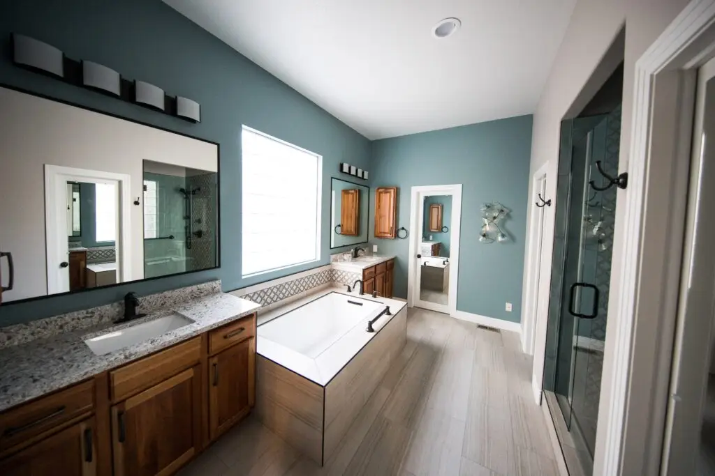 Bathroom with walk-in shower, tub, and two sinks - Houston plumbing remodels