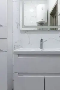 point of use water heater for shower shown in bathroom mirror