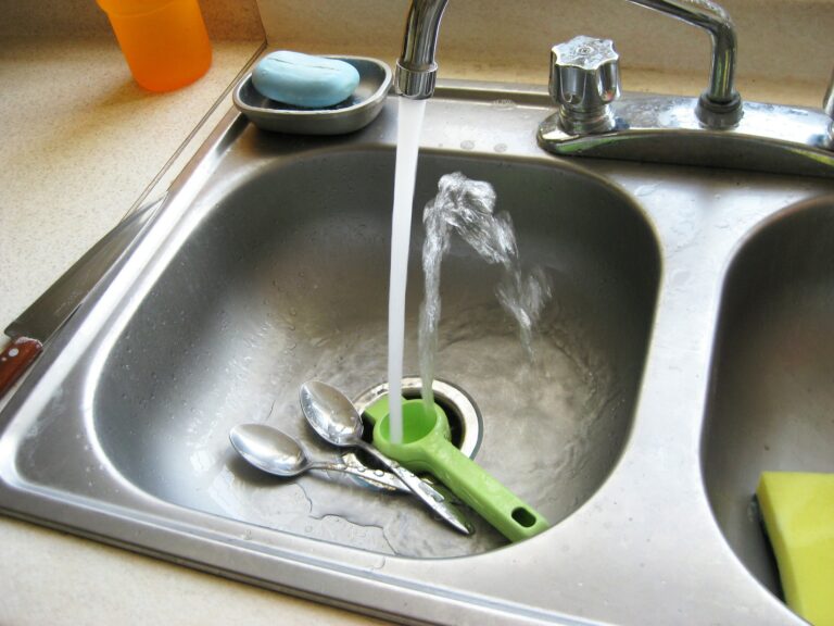 kitchen sink water running needs faucet repair from a Houston plumber