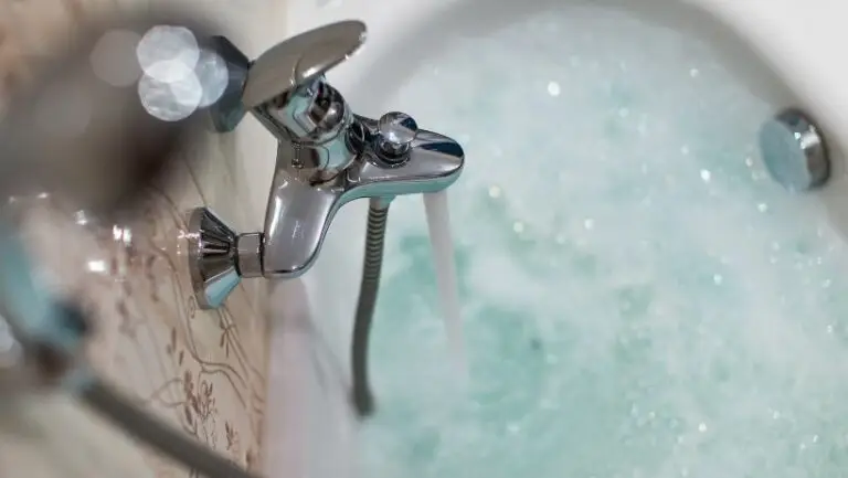 Hot water pouring into bubble bath from water heater set by Houston residential plumber