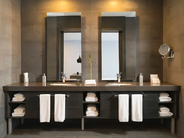 his and hers sinks in dark brown bathroom installed during Houston bathroom remodeling