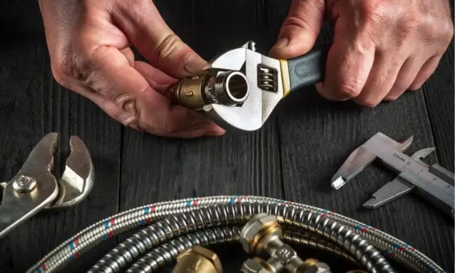 hands of master plumber working with materials for Houston plumbing repair